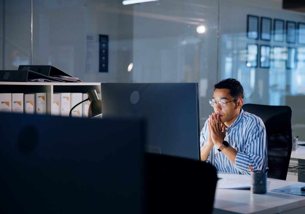 Thinking, night and computer with business man in office for profit margin report, client review an